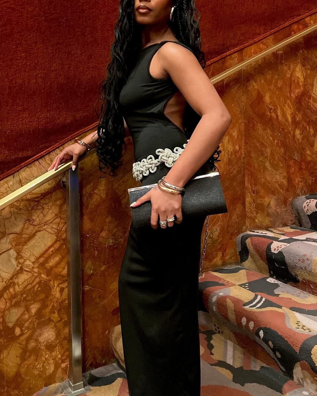 Black dress against the room's purple uplighting